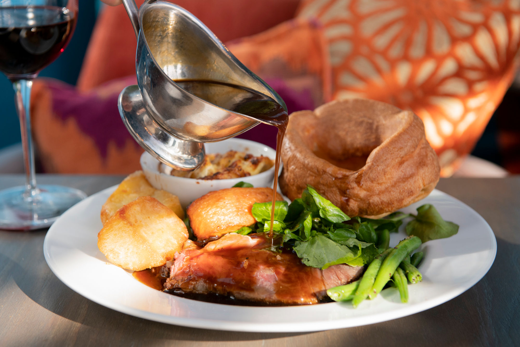 close up shot of gravy being poured on sunday roast the Cyan Brighton