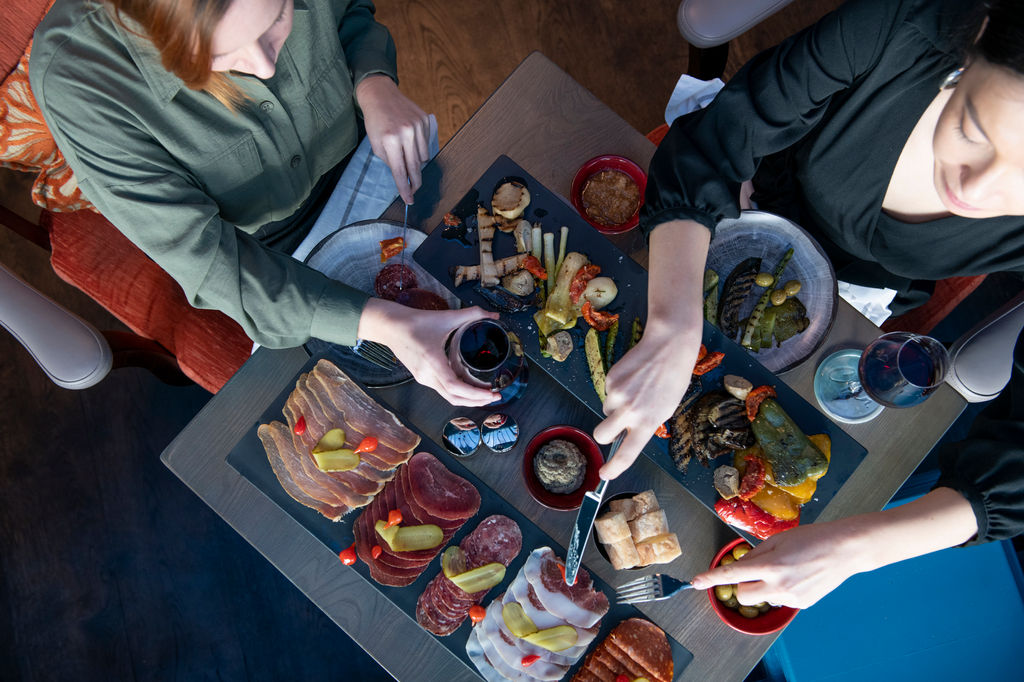 overhead shot of two ladies eating from sharing charcuterie platters, where to eat in Brighton