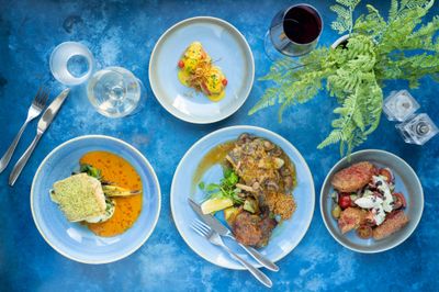 over head shot of blue table laid out with dishes