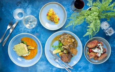 four dishes on the blue table