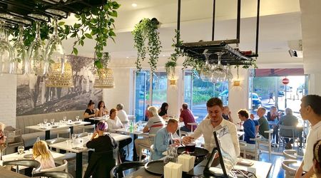 Interior shot of busy restaurant with white and botanical themed interorios
