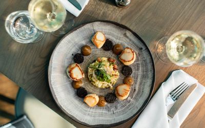 birds eye perspective. photo of seafood dish served with white wine. Cyan restaurant on Brighton seafront. Featured in our places to eat in Brighton