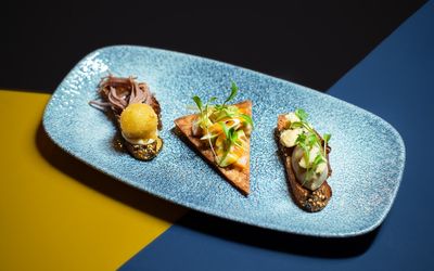 Selection of three pincho: confit duck, truffle honey and goat cheese croqueta. Marinated salmon belly and avocado with a spicy Sriracha mayonnaise, nacho and Smoked aubergine moutabal and Stilton