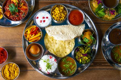 Thali platter with curries, dips, poppadoms and rice