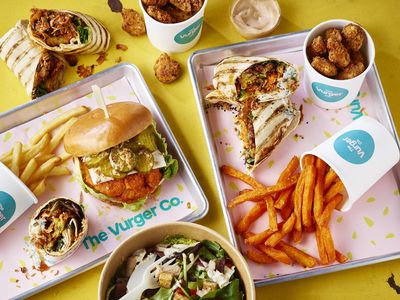 A spread of vegan fast food, burgers, wraps, chips and salad bowls. Vegan Restaurants Brighton