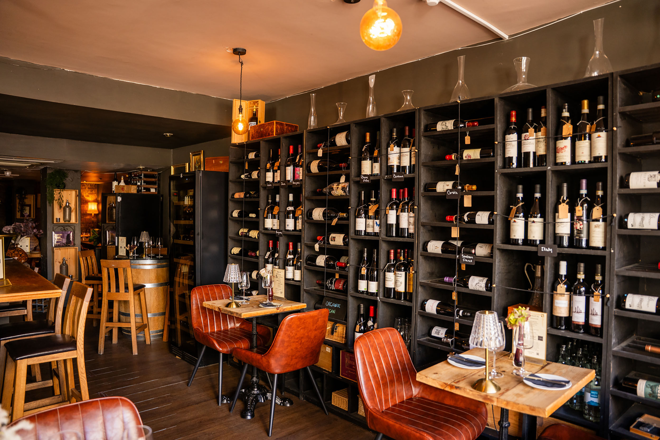 shot of the cases wine shelves and couple of tables next to them