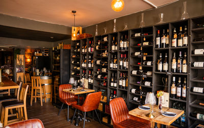 shot of the cases wine shelves and couple of tables next to them