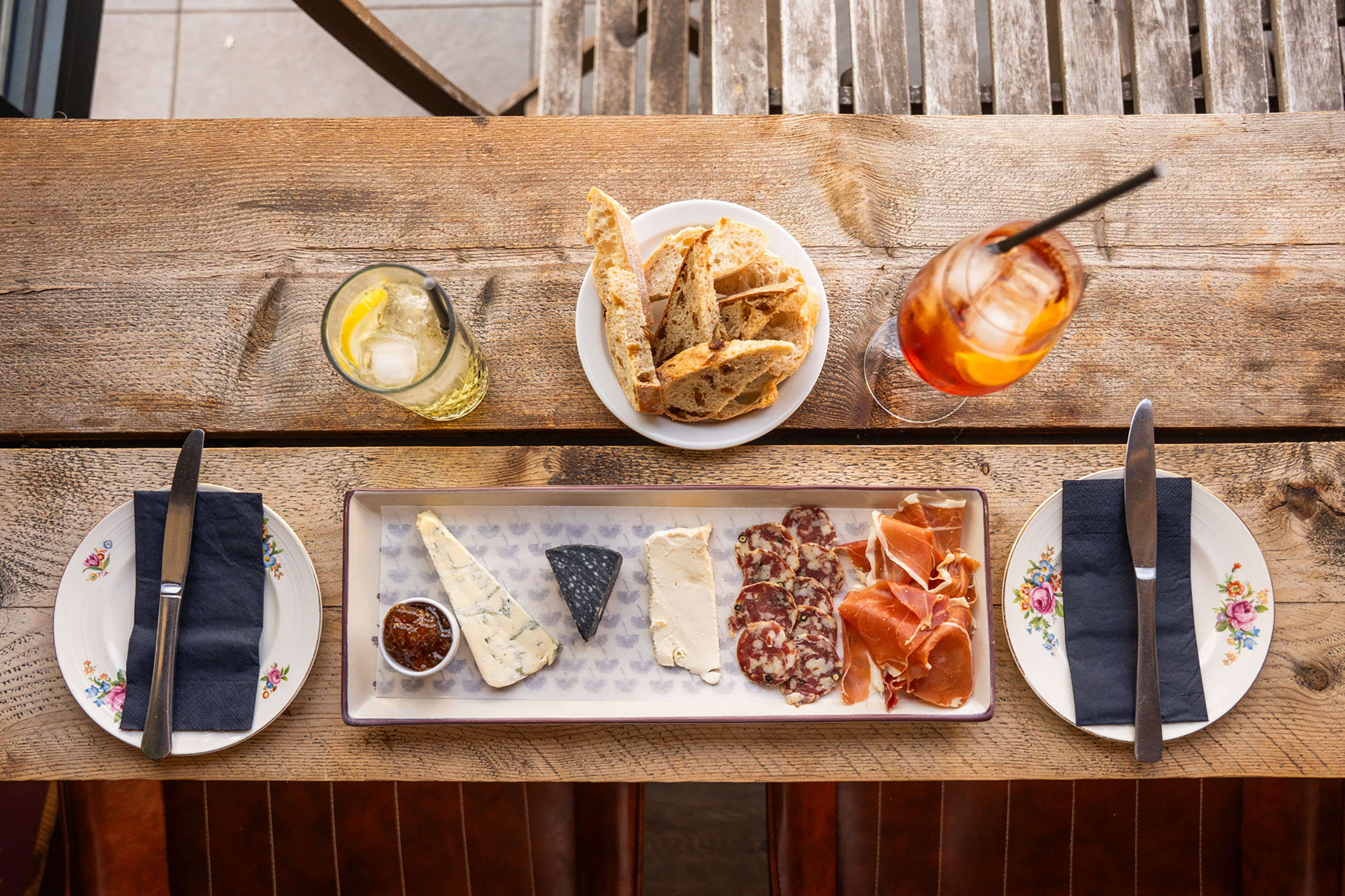 over head shot of the cheese and charcuterie board served with drinks