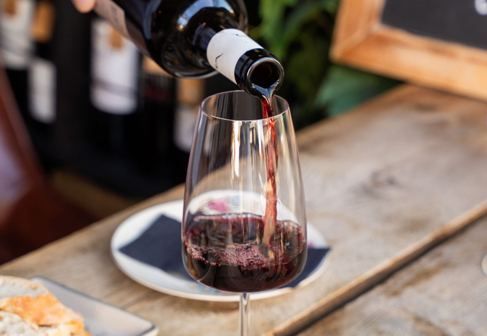 pouring red wine into a glass