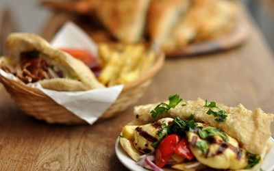 A basket of bread and fries alongside a side plate of artichokes and houmous at Yefsis Brighton. Greek Restaurant Brighton