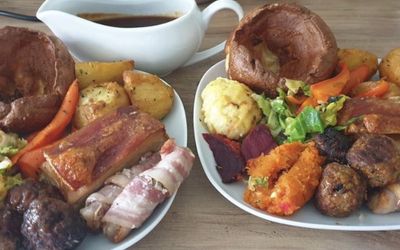 Two Sunday Roasts from The Ladies Mile Kitchen, pork, pigs in blankets, roast potatoes, Yorkshire puddings veg and gravy