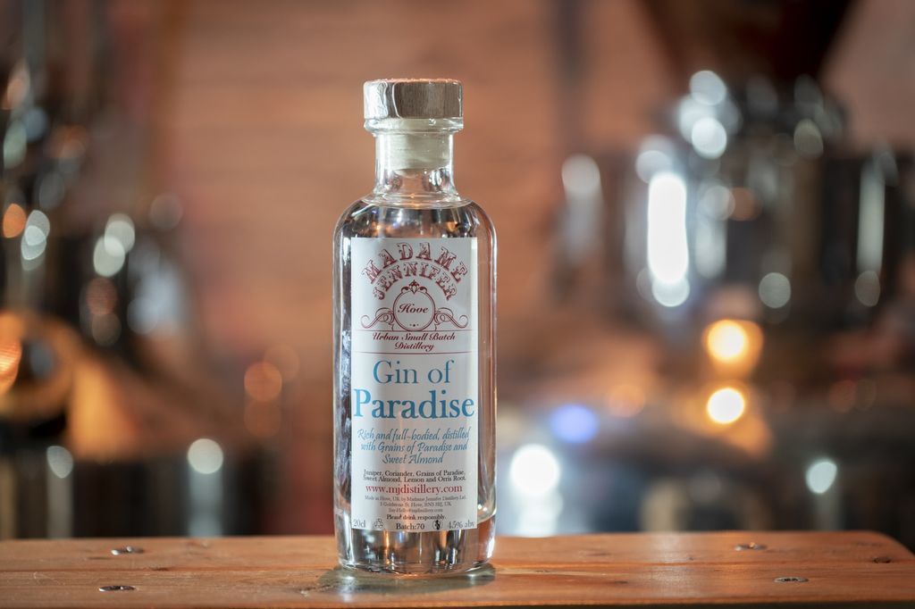 Gin of Paradise, a clear bottle of gin with a cork stopper and a white label which reads Gin of Paradise