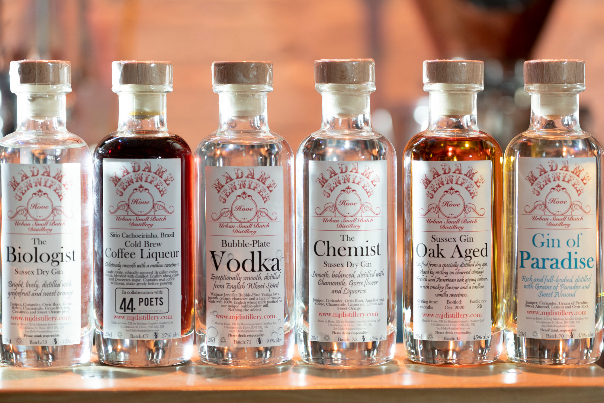 A lineup of six spirit bottles from Madame Jenifer's distillery in Hove