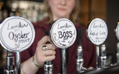 Beer taps with handwritten labels for Larrikin ales and stout