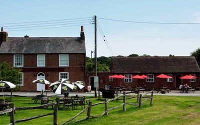 Traditional red-brick country pub with open grassy beer garden, Pubs in Sussex