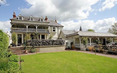 Exterior photography of Wingrove House behind the freshly cut lawn. Accommodation and a Sussex restaurant near Alfriston.