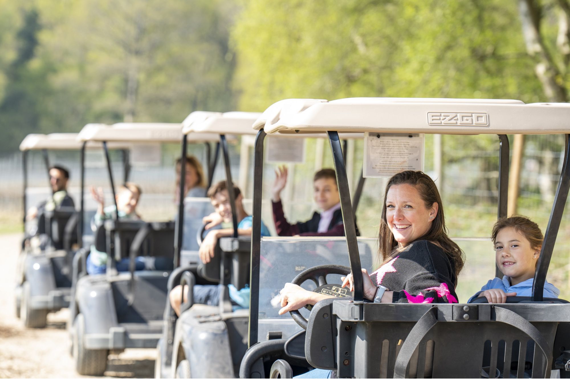 families driving in golf carts