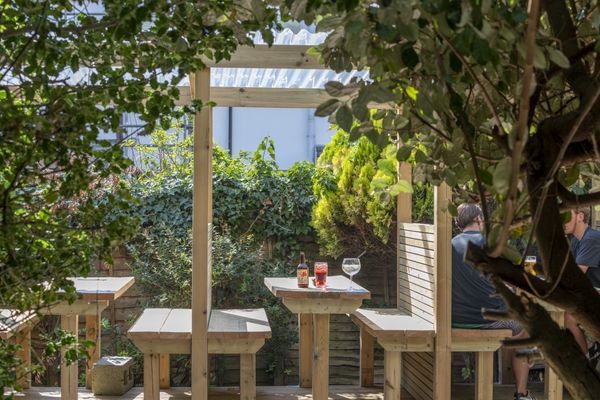 Alfresco seating in the beer garden with plants and foliage