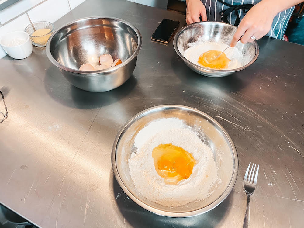 bowls of flour with egg in a 'well' in the middle