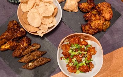 A selection of Indian sides and poppadoms served at home