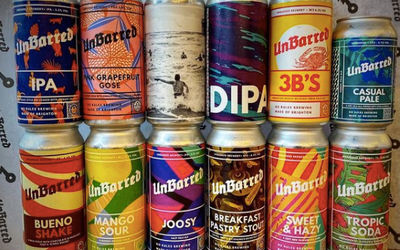 A selection of colourful labelled craft beer cans stacked up
