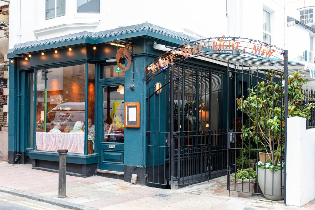entrance to burnt orange Brighton. The entrance goes through their courtyard which is an alfresco area. The facade is dark blue. Burnt Orange could also be considered a wine bar Brighton, Brighton restaurant, Brighton cocktails. Voted best restaurant at the BRAVO Awards in 2022 and 2023