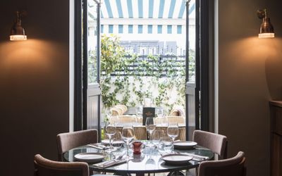 A view through the restaurant into the green courtyard. Burnt Orange in Brighton, showcasing the green courtyard terrace. Best restaurants in Brighton in 2023, Burnt Orange. 2023 BRAVO Award winner. Best restaurants Brighton. Best places to eat in Brighton Top 20 round-up