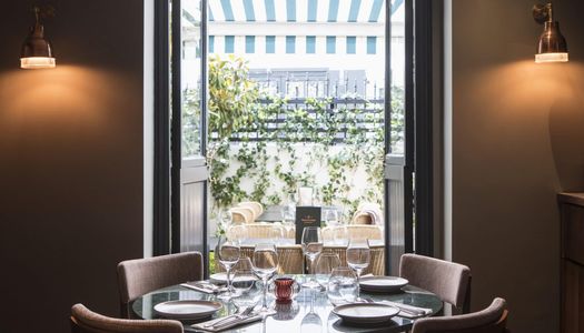 A view through the restaurant into the green courtyard. Burnt Orange in Brighton, showcasing the green courtyard terrace. Best restaurants in Brighton in 2023, Burnt Orange. 2023 BRAVO Award winner. Best restaurants Brighton. Best places to eat in Brighton Top 20 round-up