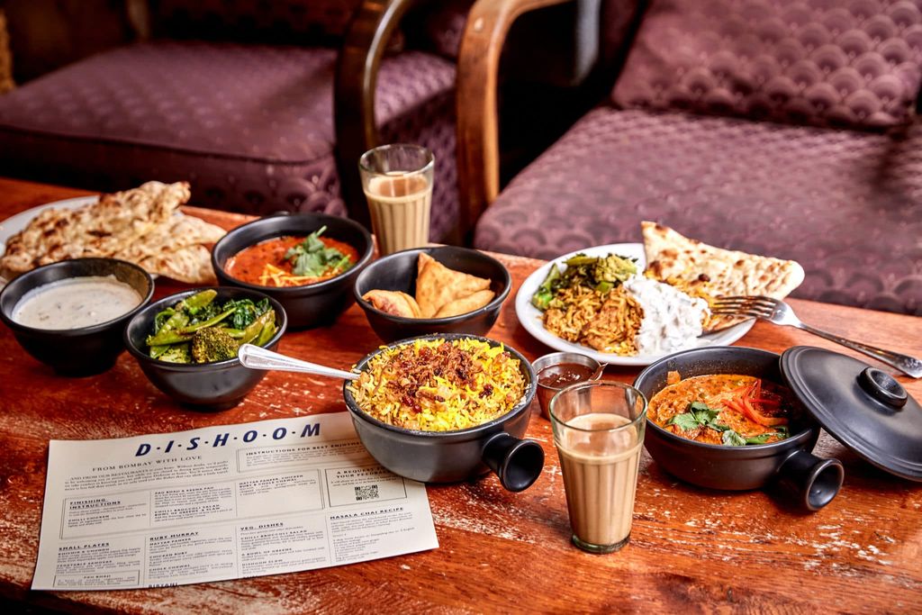 a selection of curries laid out on a low table