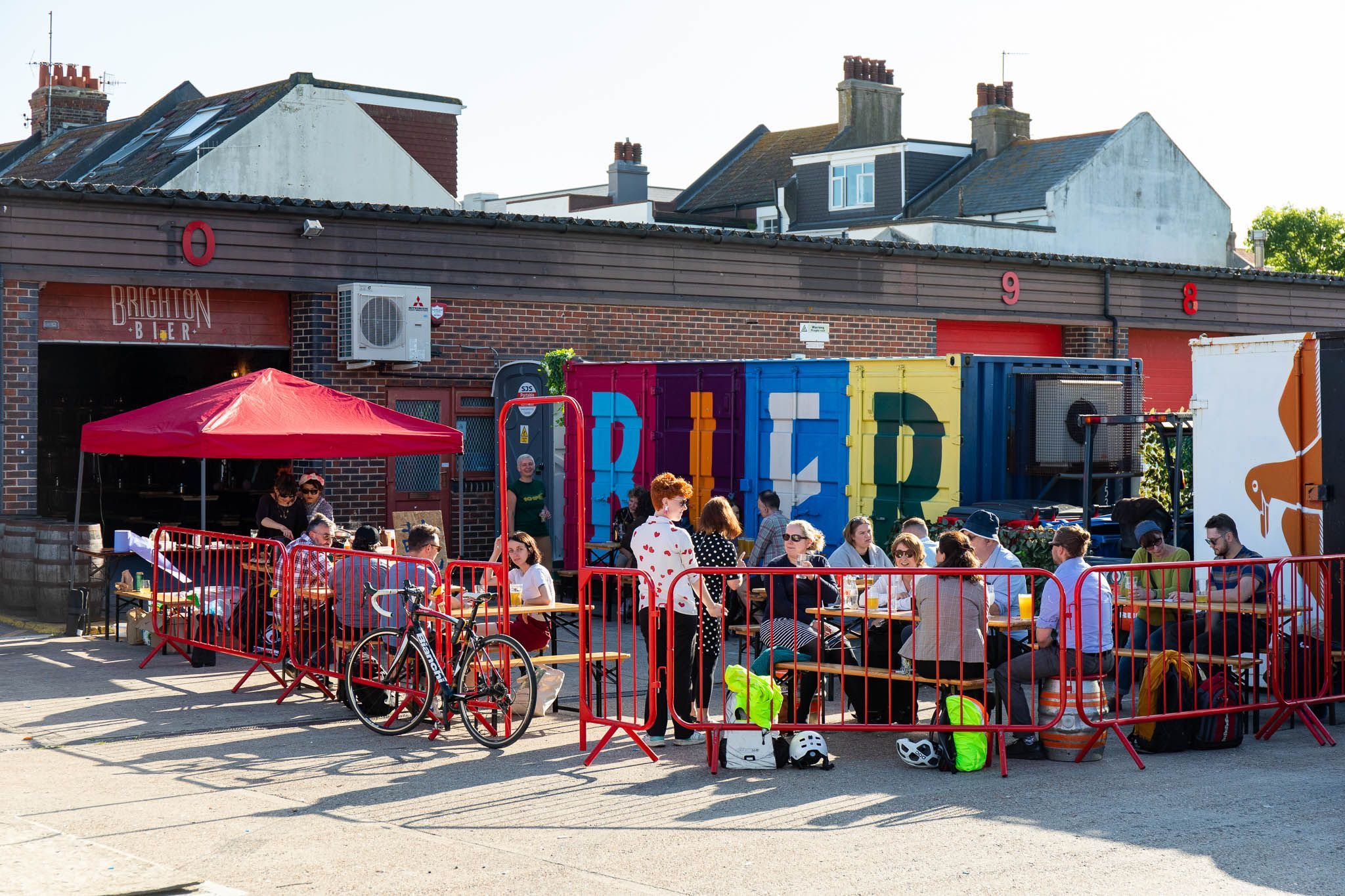 people sitting outside the brighton bier brewery