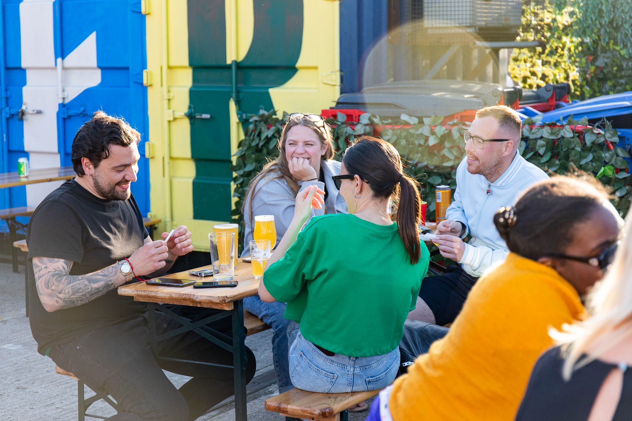 group of friends having fun and enjoying their beer in the garden of the brighton bier brewery