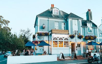 Exterior street photo of The Cleveland Arms pub with alfresco seating.