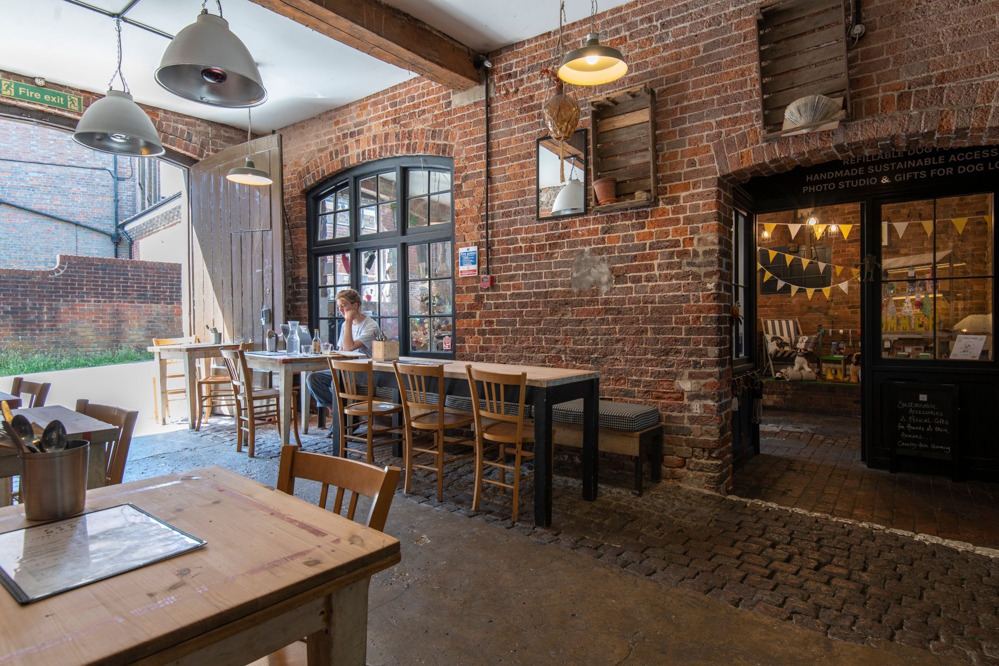 outdoor seating of the needlekmakers, wooden tables and chairs