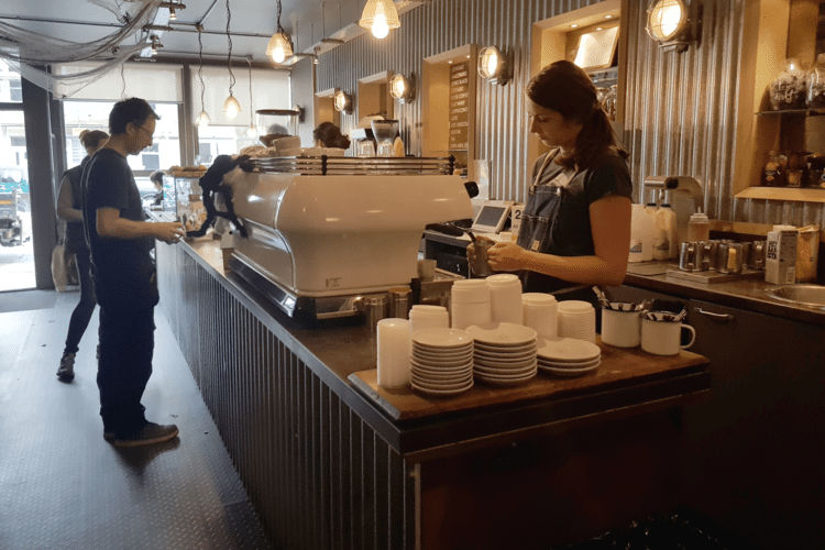 Inside Goldstone Small Batch coffee shop, a woman is making coffee
