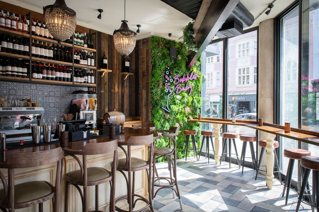 green plant wall inside the venue with bubbles baby header