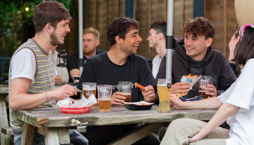 group of people enjoying beer in pubs garden