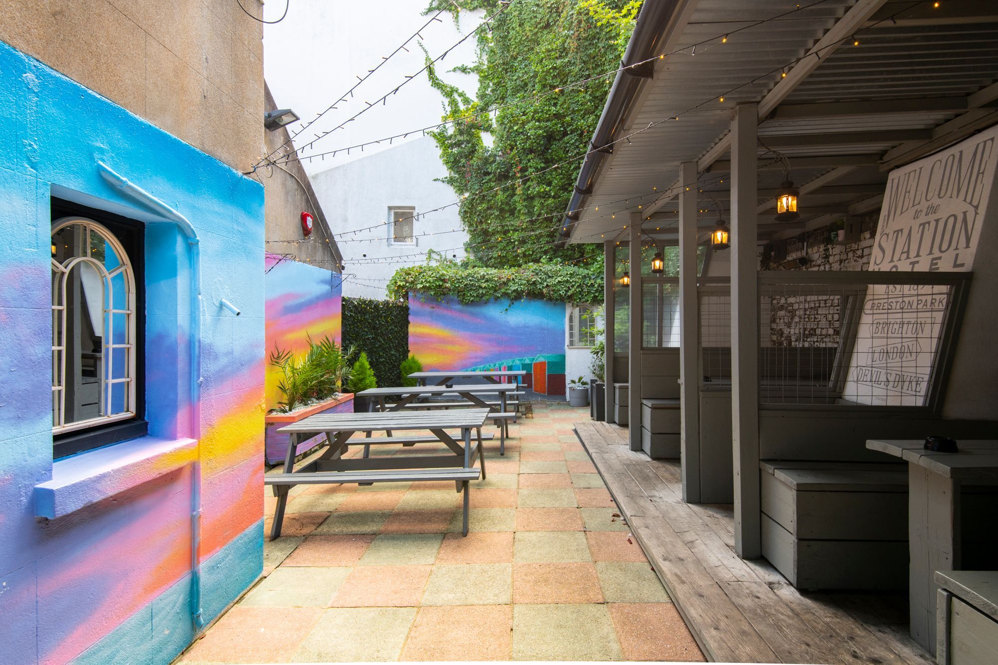 courtyard with colorful painted walls and private area with wooden benches
