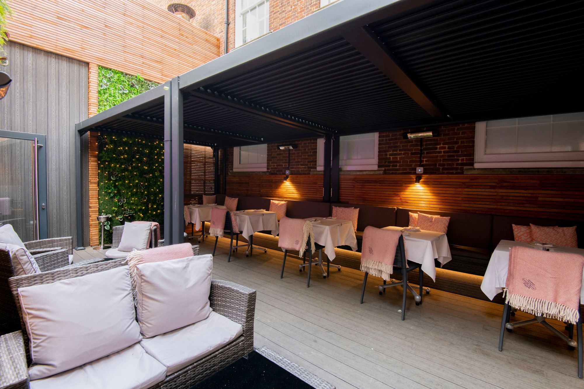 outdoor seating area with duvet covers on sofas and chairs