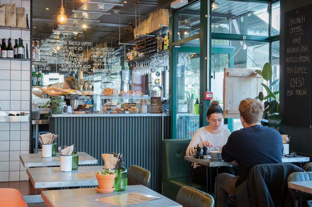 interior photo of cafe coho hove, orange diner, people having food