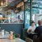 interior photo of cafe coho hove, orange diner, people having food