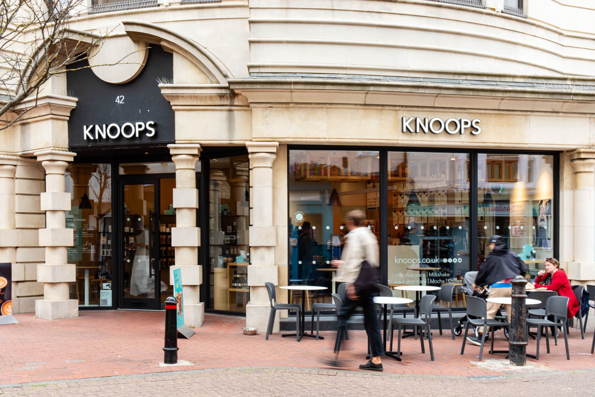 exterior shot of the Knoops Brighton building located in the Lanes, people walking by and some sitting outside
