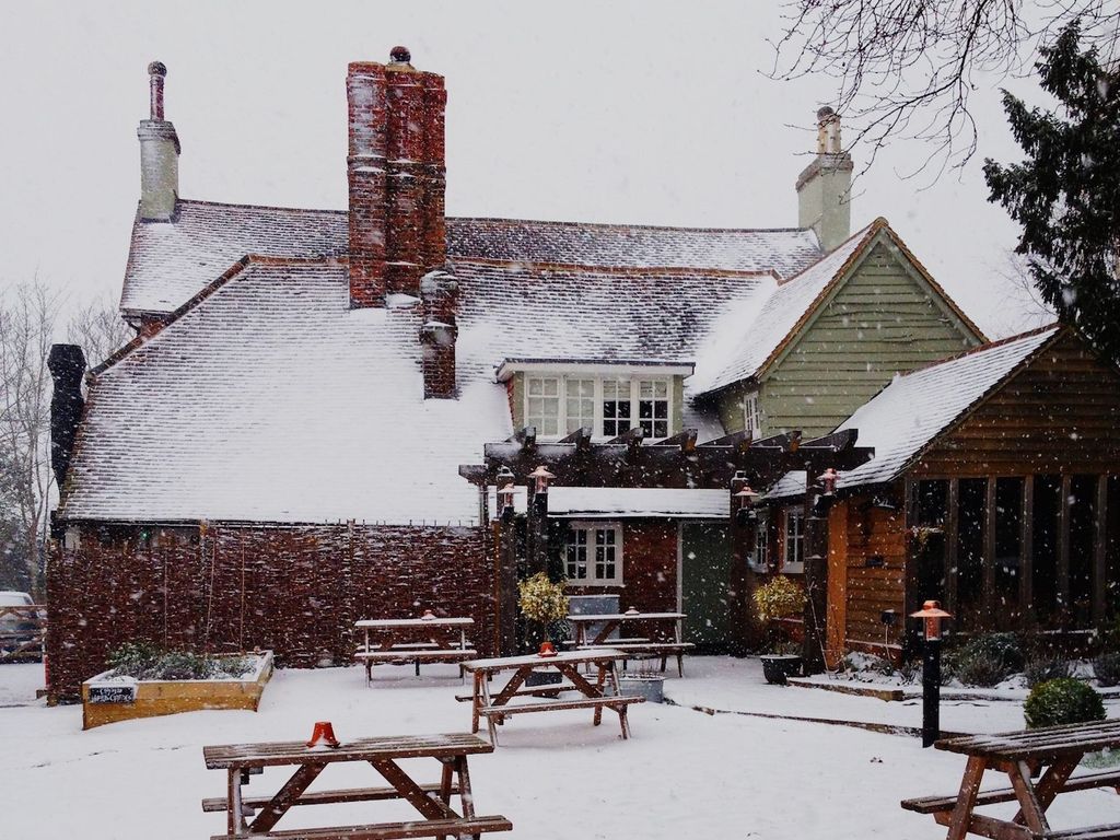 A snow covered country pub and garden