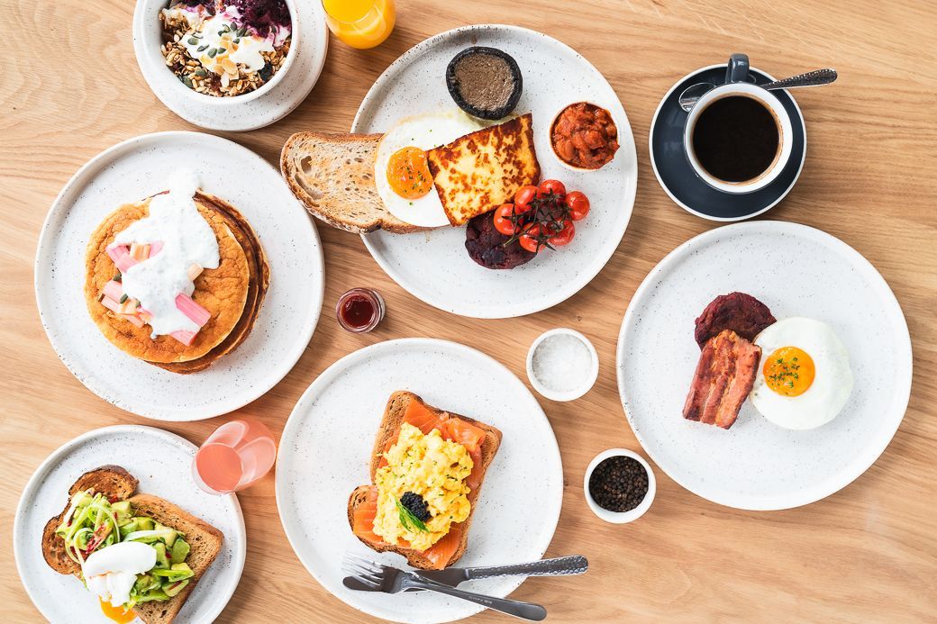 overhead shot of the table laid out with breafask dishes and coffee