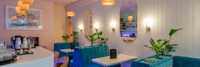 inside the 2 Church Street, tiffany blue diners and bar chairs, white table, mirrors on the wall