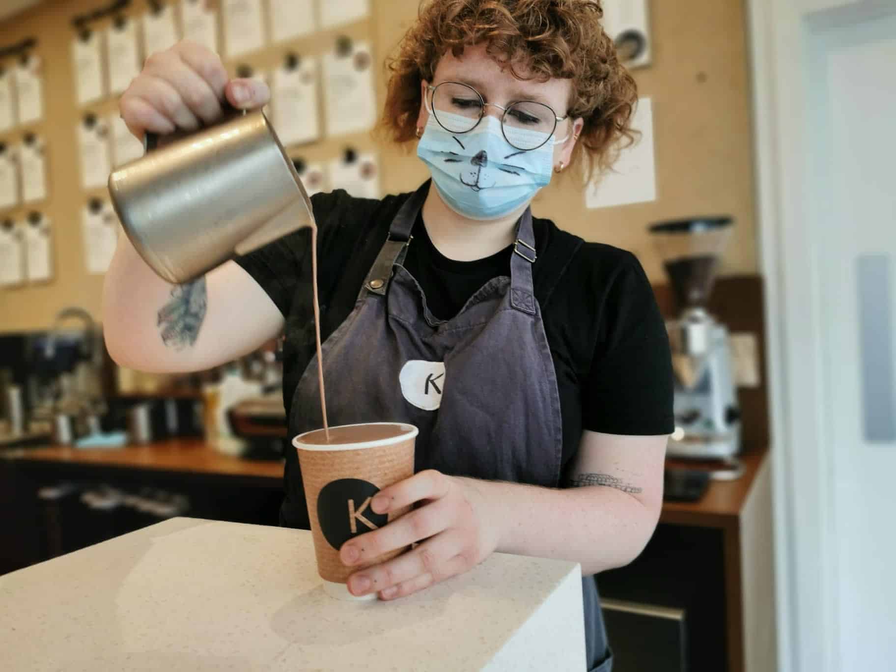 girl pouring hot chocolate in the cup