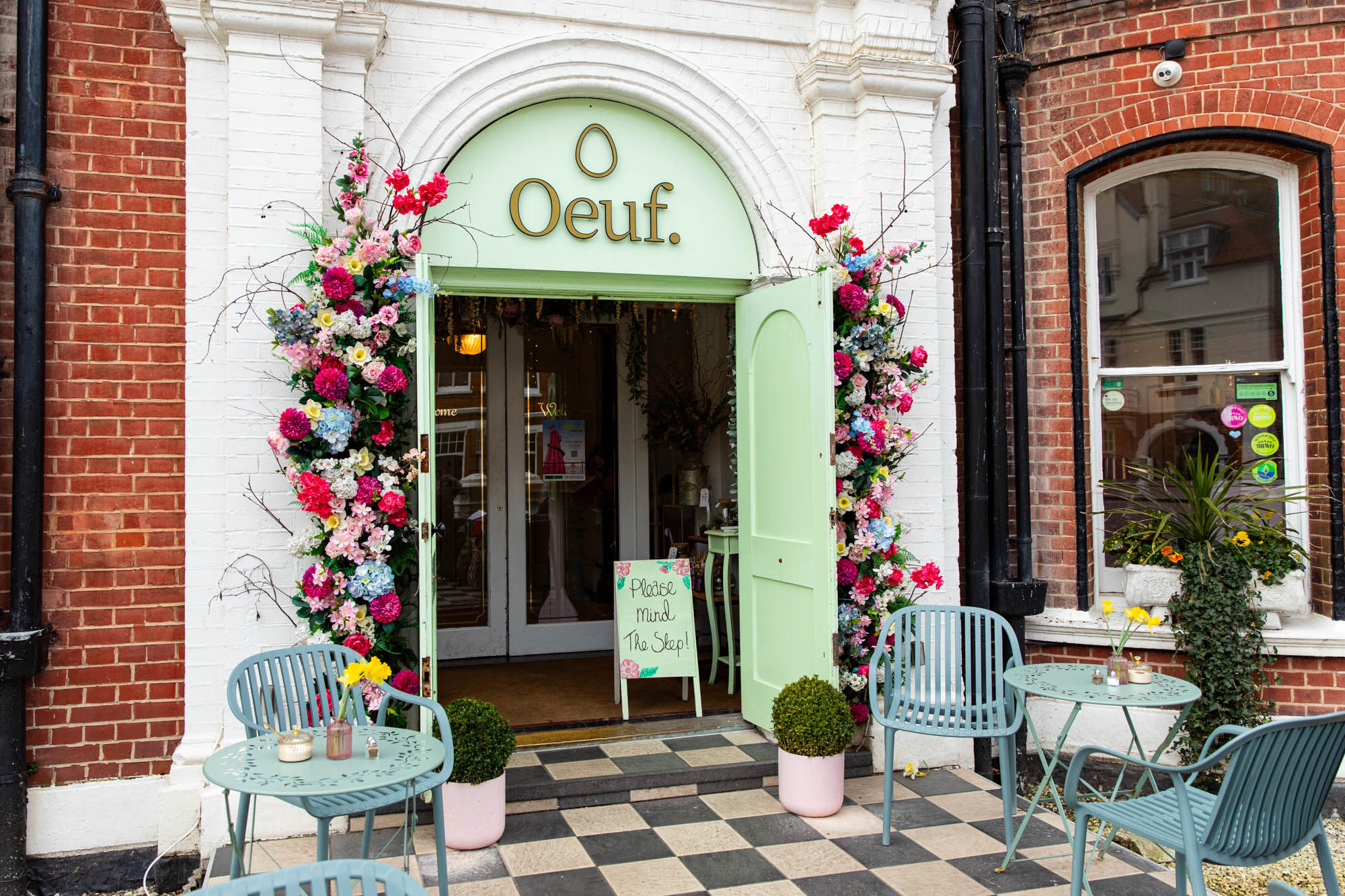 The exterior of Oeuf cafe in Hove. with lime green doors