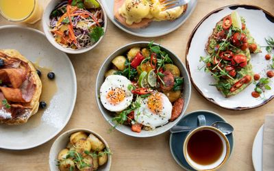 overhead shot of three main dishes served with tea and orange. Brighton brunch award
