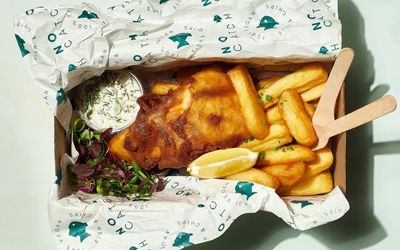 Vegan fish and chips in a takeaway box