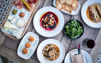 table laid out with sharing plates at Market restaurant in Hove. Market features in our round up of Places to eat in Brighton and Hove