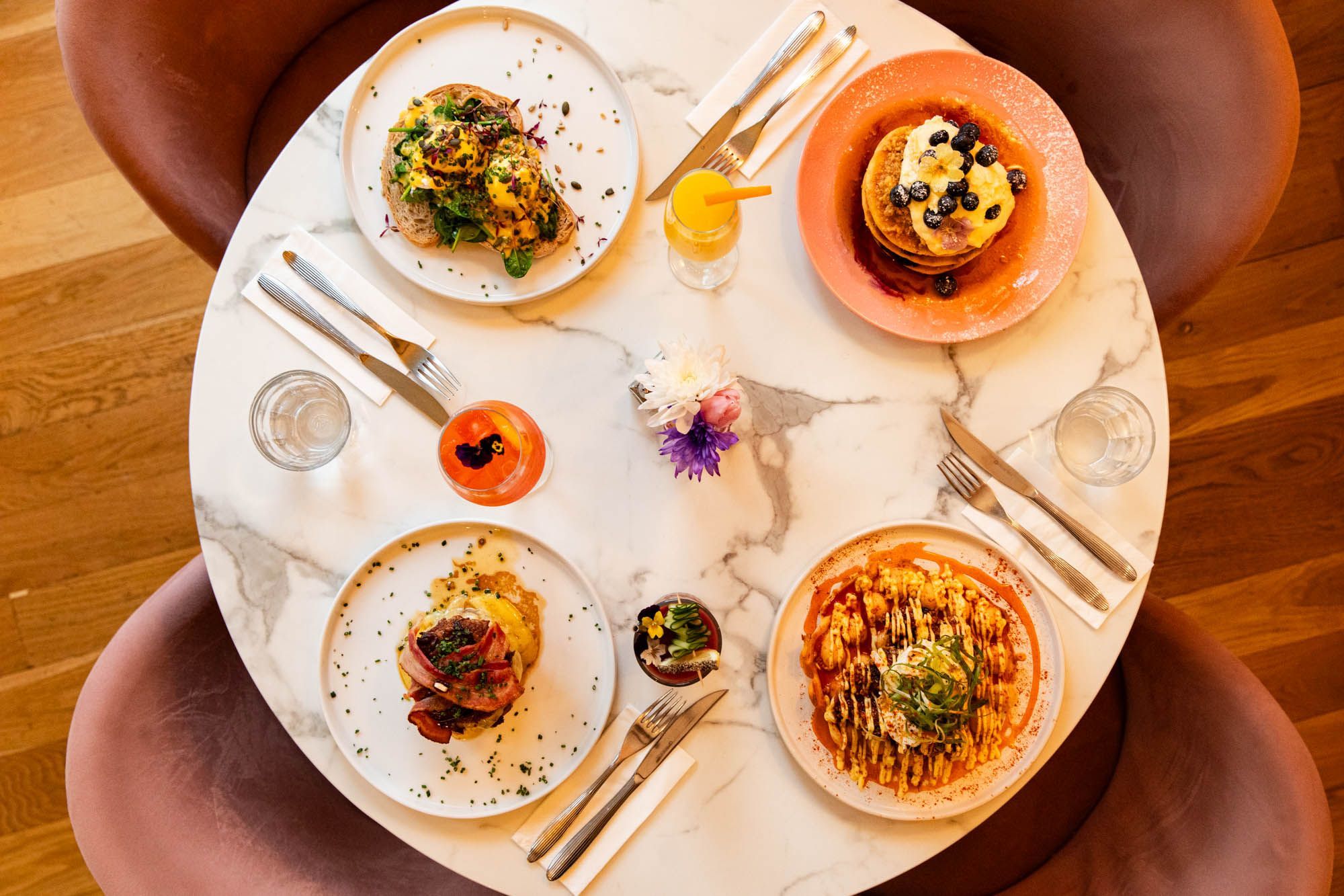 over head shot of the marble table populated with four Oeuf dishes at the Oeuf Cafe in Brighton